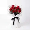 11 red roses bouquet white background Frontal shot of 11 premium red roses with white misty accents, wrapped in modern white paper with black mesh and ribbon.