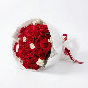 33 red roses bouquet side profile Side perspective of the large red rose bouquet showcasing the voluminous design and elegant red satin ribbon.