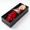 boxed red roses side angle Side angle of the 19 red roses gift box showcasing the sleek black packaging and elegant red ribbon.