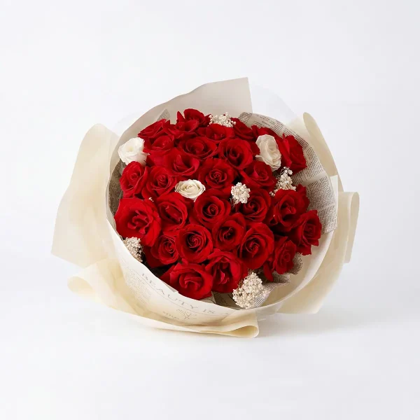 eternal flame red roses main view Frontal view of 33 premium red roses bouquet with white accents in newspaper wrapping for China delivery.
