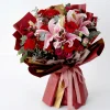 grand royal bouquet side profile Side view of the luxury red and pink bouquet, showcasing the professional multi-layered wrapping and elegant pink ribbon.