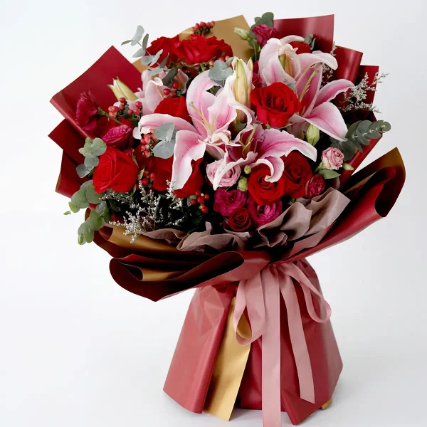 grand royal bouquet side profile Side view of the luxury red and pink bouquet, showcasing the professional multi-layered wrapping and elegant pink ribbon.