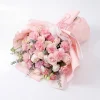 pink carnation bouquet horizontal lay view Horizontal view of the pink carnation and rose arrangement laying flat, showcasing the lush volume and abundance of fresh blooms.