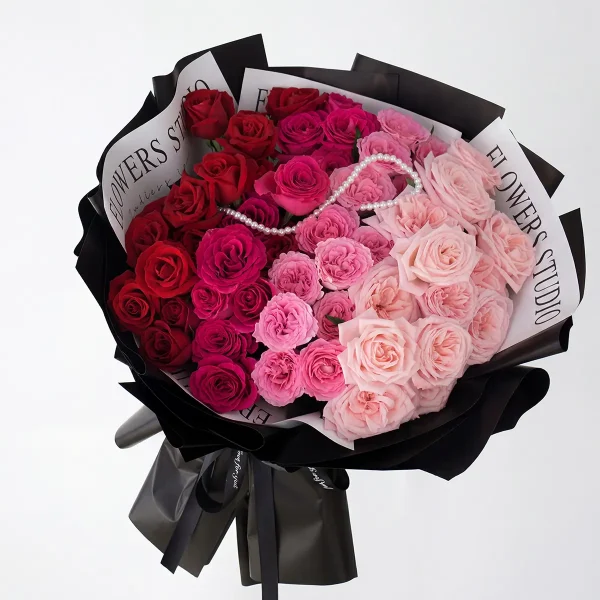 pink gradient rose pearl bouquet main Side view of the luxury ombre rose bouquet, highlighting the professional black studio-style wrapping and sleek ribbon.