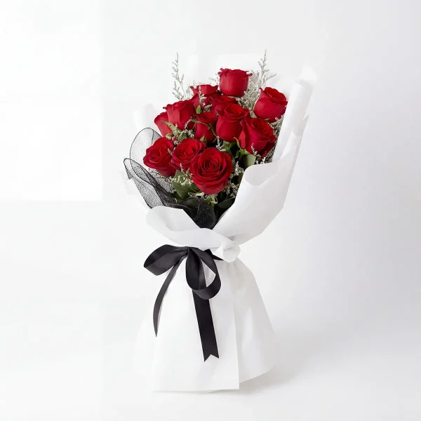 red rose bouquet side profile black ribbon Side view of the premium red rose bouquet, highlighting the elegant black satin ribbon and the stylish layered wrapping.