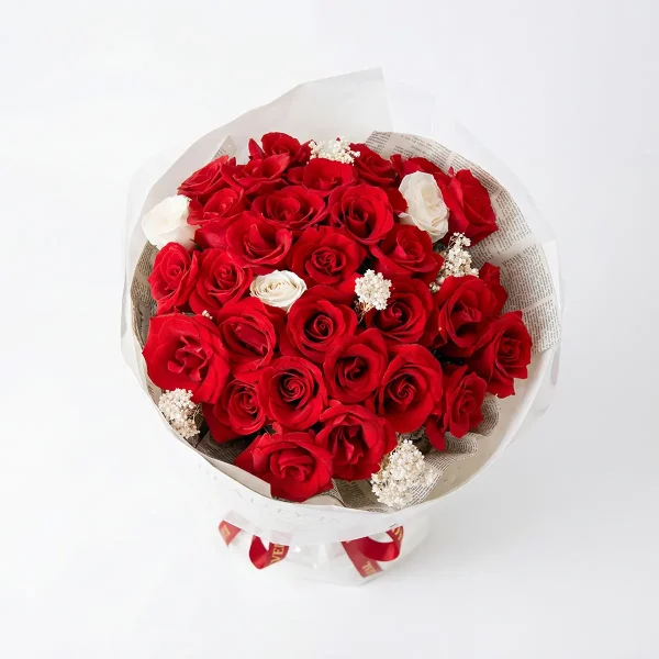 red rose bouquet top overhead view Top-down view of the 33 red roses arrangement, displaying a lush sea of fresh blooms and white floral accents.