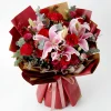 red rose lily bouquet top view Overhead view showing the rich density of blooming lilies, roses, and red berries with fresh eucalyptus leaves.