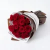 red roses bouquet laying horizontal. A horizontal laying view of 19 red roses showcasing the density and freshness of every bloom.