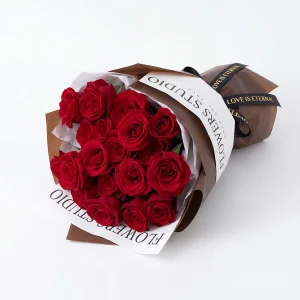 red roses bouquet laying horizontal. A horizontal laying view of 19 red roses showcasing the density and freshness of every bloom.