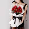 red roses bouquet model presentation china A model holding a stylish bouquet of 11 red roses, showcasing the grand size and elegant black and white gift presentation.