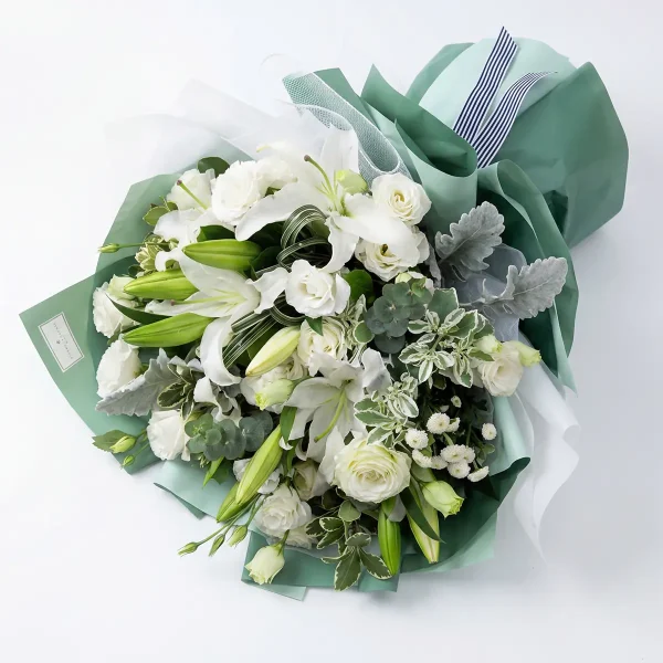 white lily rose bouquet top view. Overhead perspective of the white mixed bouquet, showing the lush density of blooming lilies and delicate white chrysanthemums.
